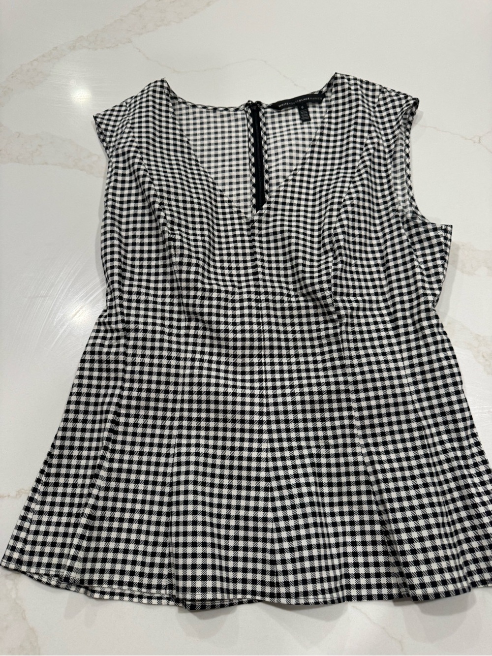 White House black market black, and white blouse with zip up back and sleeveless